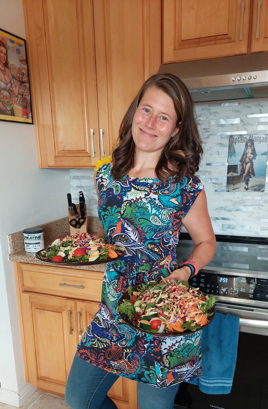 Lin holding two colorful salads she prepared